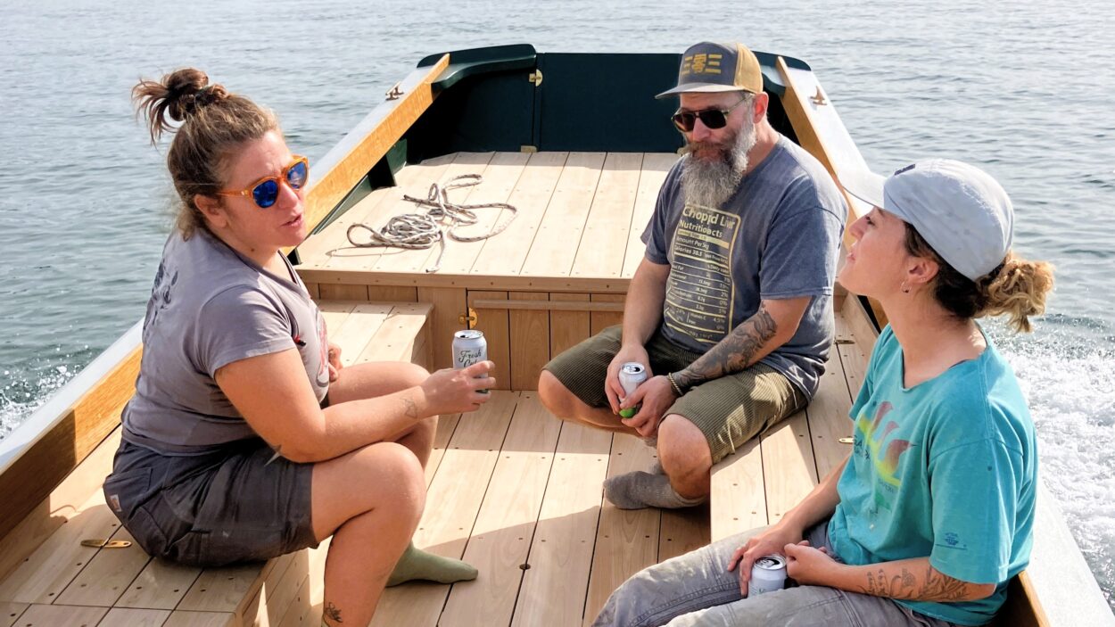 Boatbuilders relaxing on new boat.