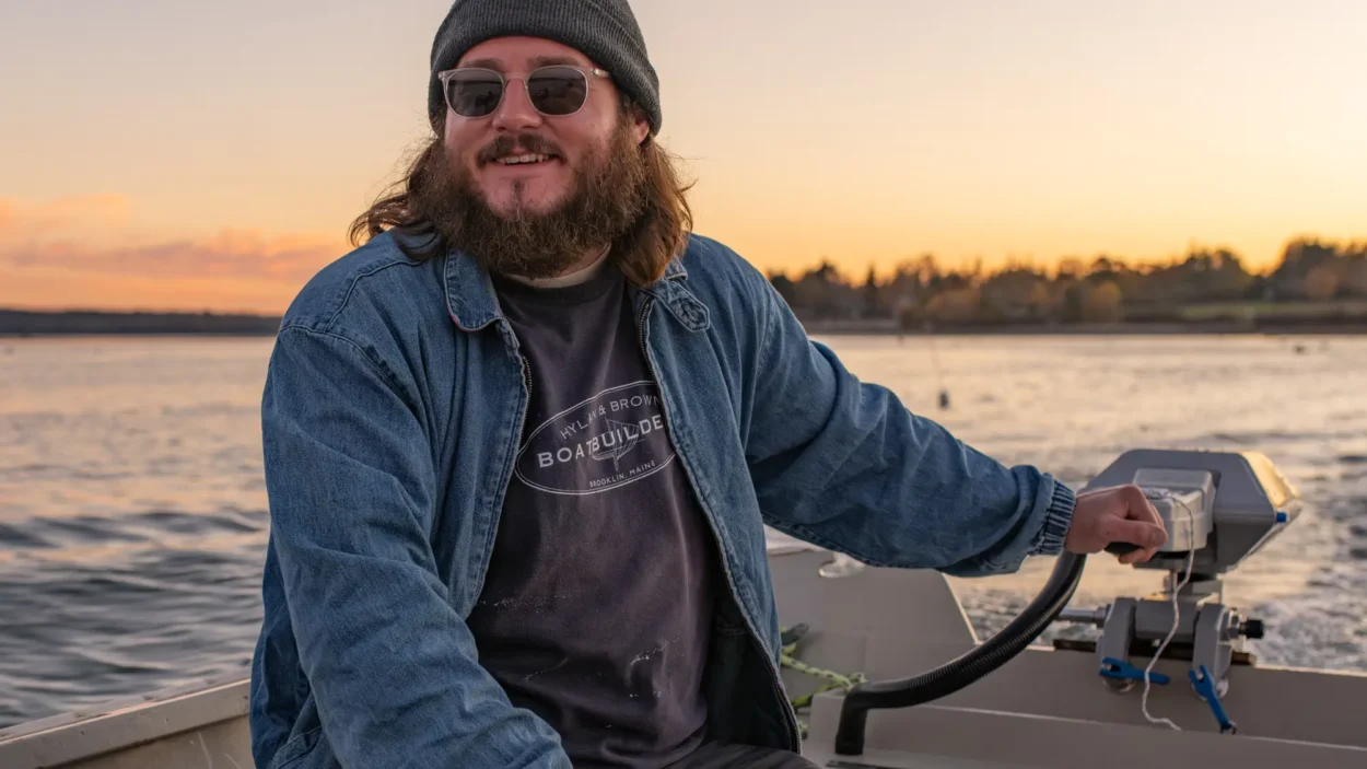 Man in skiff at sunset