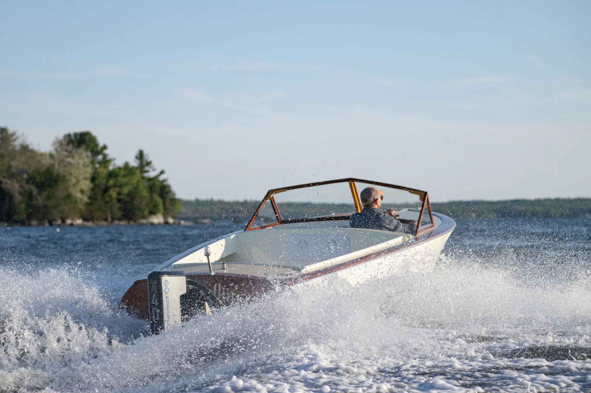 Electric boat underway with lots of spray