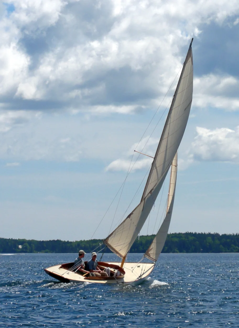 Restored sloop under sail.